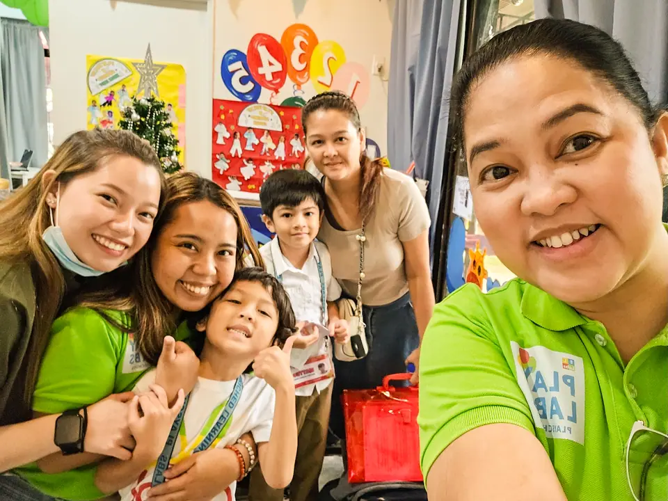 Teacher Ella with ELLabs teachers and a student