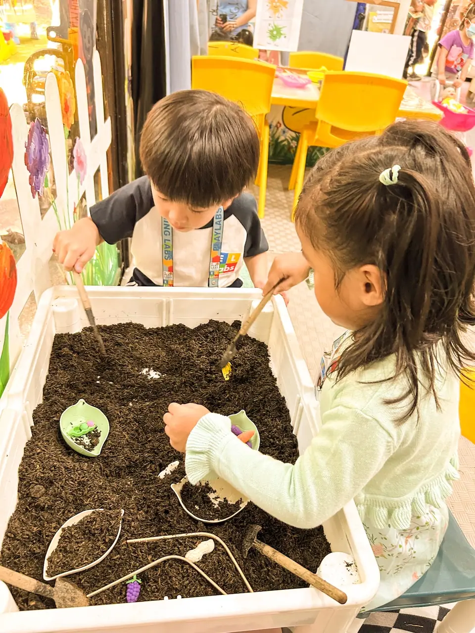 Children planting seedlings in a soil tray