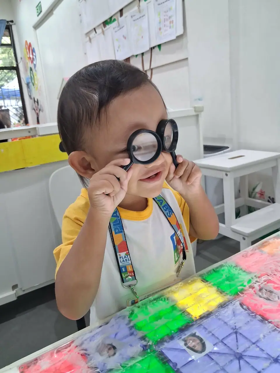 Child examining colorful learning materials